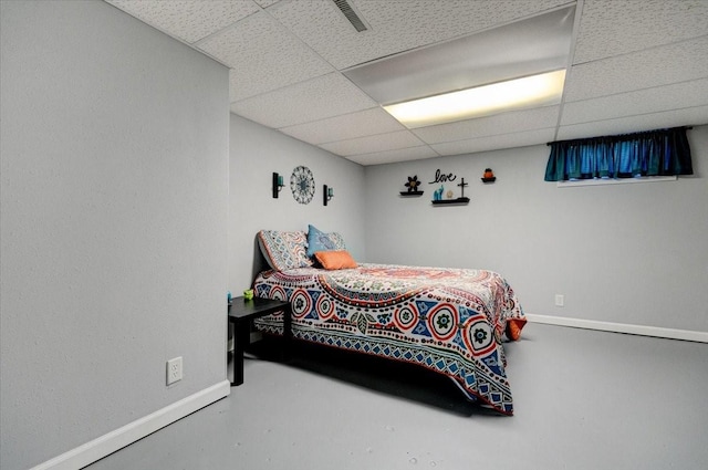 5613 College Ave, Des Moines, IA 50310 - bedroom with a paneled ceiling and finished concrete flooring
