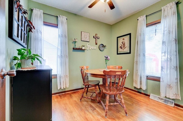 5613 College Ave, Des Moines, IA 50310 - dining space featuring a ceiling fan, healthy amount of natural light, and light wood-style flooring