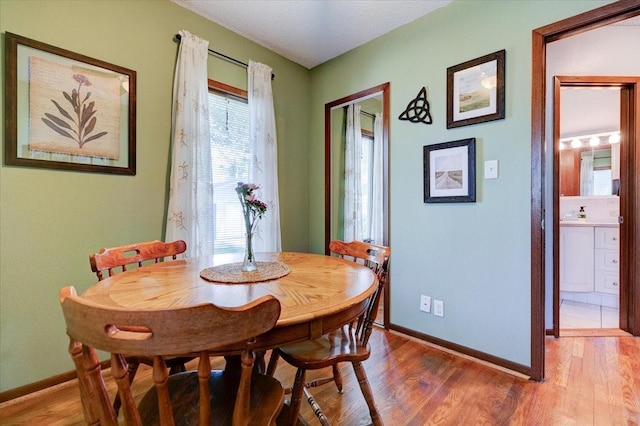 5613 College Ave, Des Moines, IA 50310 - dining space with baseboards and light wood finished floors