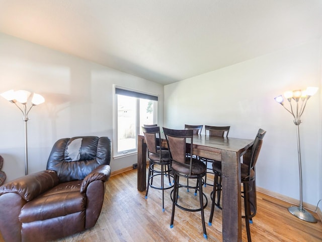 3303 Ashwood Dr, Urbandale, IA 50322 - dining area with light wood-style floors and baseboards