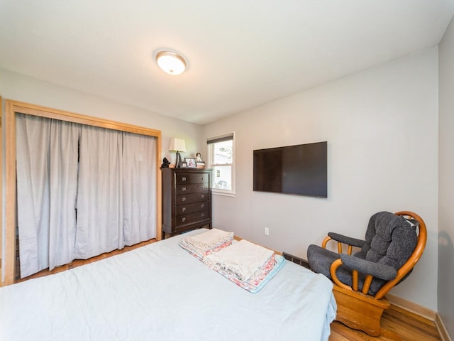 3303 Ashwood Dr, Urbandale, IA 50322 - bedroom featuring wood finished floors and baseboards