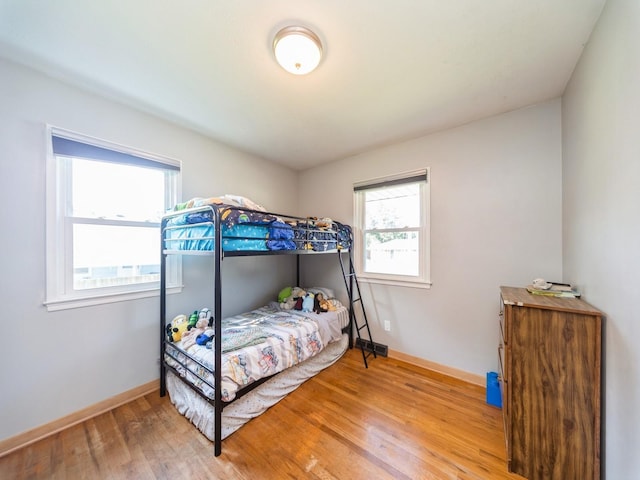 3303 Ashwood Dr, Urbandale, IA 50322 - bedroom featuring wood finished floors and baseboards