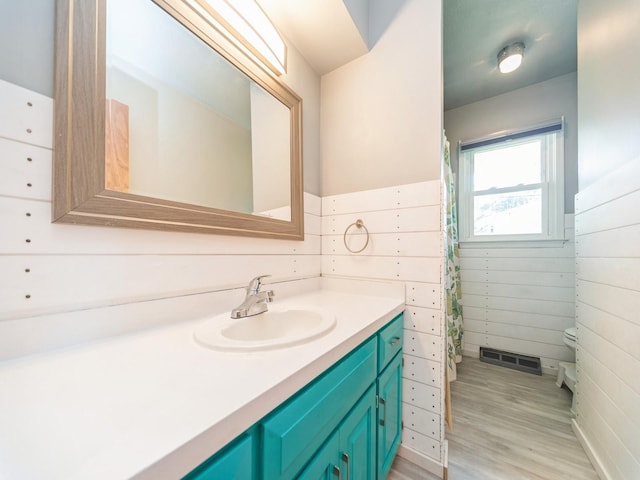 3303 Ashwood Dr, Urbandale, IA 50322 - full bath with vanity, wood finished floors, and curtained shower