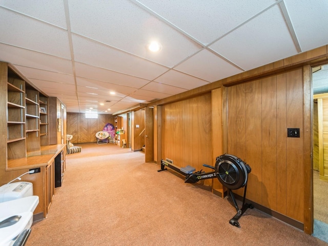 3303 Ashwood Dr, Urbandale, IA 50322 - exercise area featuring light carpet, wood walls, a paneled ceiling, and recessed lighting
