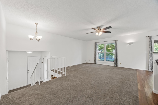 7005 Surrey Dr NE, Cedar Rapids, IA 52402 - unfurnished room featuring a chandelier, healthy amount of natural light, a textured ceiling, a ceiling fan, and dark wood finished floors