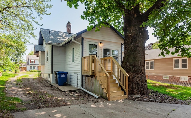 910 30th St, Des Moines, IA 50312 - view of front of property with a chimney and roof with shingles
