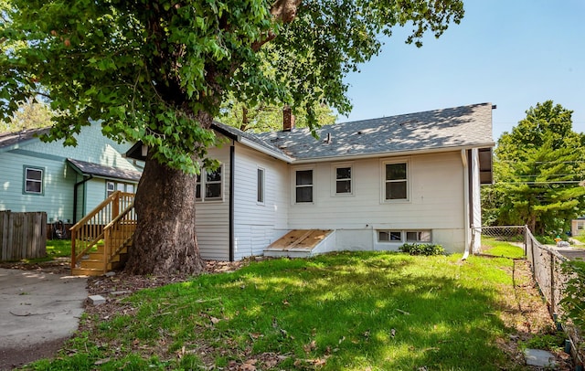 910 30th St, Des Moines, IA 50312 - rear view of house featuring a chimney and a shingled roof