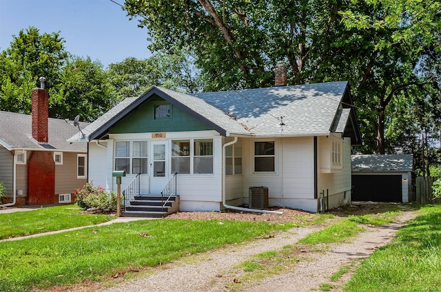 910 30th St, Des Moines, IA 50312 - bungalow-style home with a front lawn, an outbuilding, a shingled roof, a chimney, and entry steps