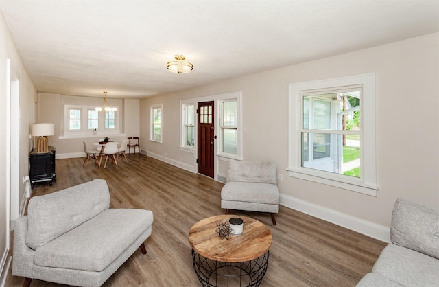 910 30th St, Des Moines, IA 50312 - living area featuring a chandelier and wood finished floors