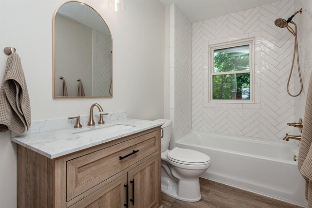 910 30th St, Des Moines, IA 50312 - full bathroom with vanity, wood finished floors, and tub / shower combination