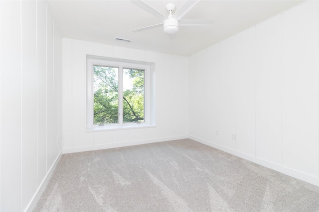 1410 20th St Unit 20, West Des Moines, IA 50265 - empty room featuring carpet floors, a ceiling fan, and a decorative wall