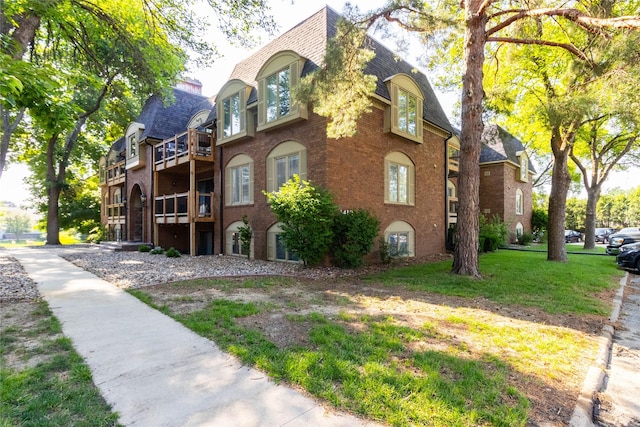 1410 20th St Unit 20, West Des Moines, IA 50265 - view of home's exterior with brick siding, a shingled roof, and mansard roof