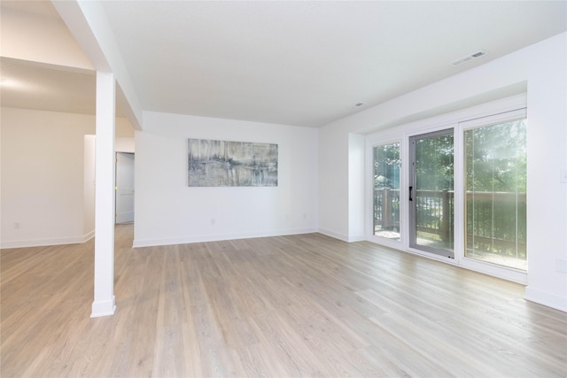 1410 20th St Unit 20, West Des Moines, IA 50265 - unfurnished living room featuring light wood-style flooring and baseboards