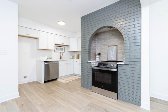 1410 20th St Unit 20, West Des Moines, IA 50265 - kitchen featuring appliances with stainless steel finishes, light wood-style flooring, light countertops, and white cabinets