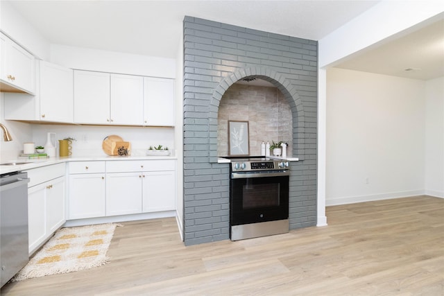 1410 20th St Unit 20, West Des Moines, IA 50265 - kitchen with appliances with stainless steel finishes, light countertops, white cabinets, and light wood finished floors
