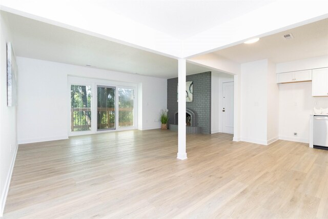 1410 20th St Unit 20, West Des Moines, IA 50265 - unfurnished living room with light wood-style floors and a fireplace
