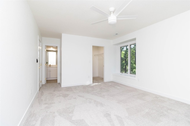 1410 20th St Unit 20, West Des Moines, IA 50265 - unfurnished bedroom featuring light carpet, a spacious closet, ensuite bath, and ceiling fan