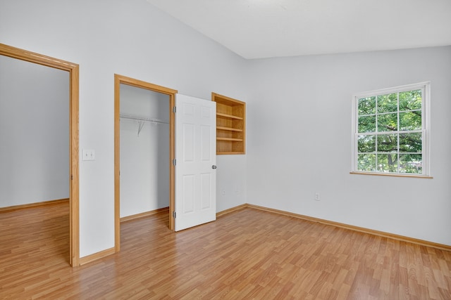 8302 Westown Pkwy Unit 7106, West Des Moines, IA 50266 - unfurnished bedroom with light wood-type flooring, a closet, and lofted ceiling