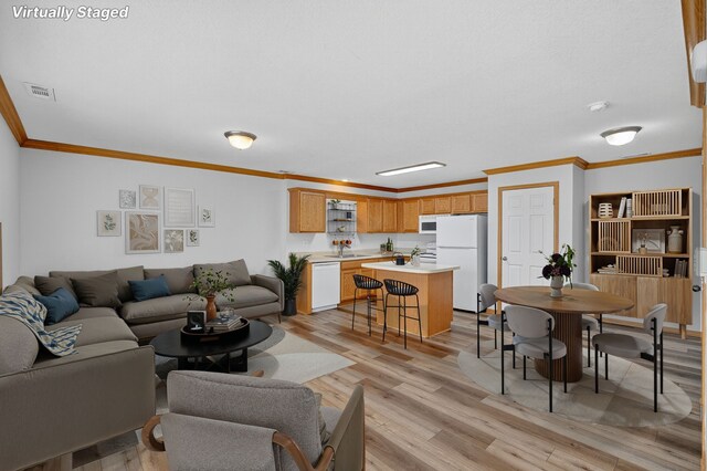 8302 Westown Pkwy Unit 7106, West Des Moines, IA 50266 - living room featuring crown molding and light wood-type flooring