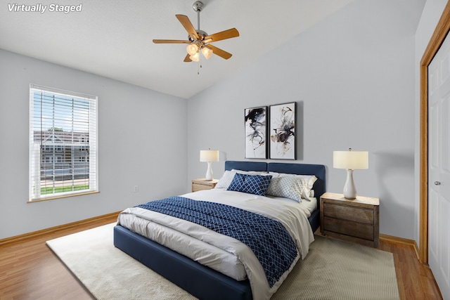 8302 Westown Pkwy Unit 7106, West Des Moines, IA 50266 - bedroom with wood finished floors, lofted ceiling, and a closet