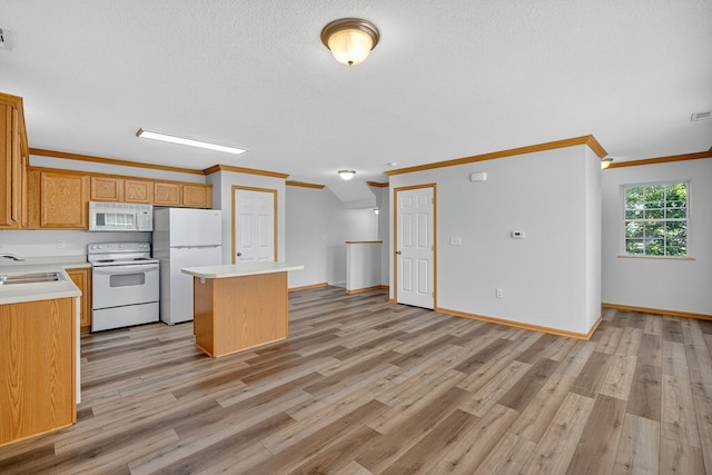 8302 Westown Pkwy Unit 7106, West Des Moines, IA 50266 - kitchen with crown molding, a center island, white appliances, light countertops, and light wood-style floors
