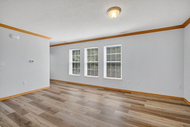 8302 Westown Pkwy Unit 7106, West Des Moines, IA 50266 - unfurnished room featuring crown molding, light wood-style flooring, and a textured ceiling