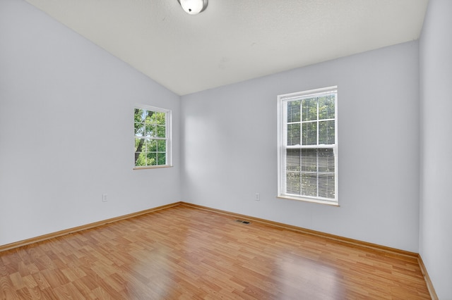 8302 Westown Pkwy Unit 7106, West Des Moines, IA 50266 - unfurnished room featuring light wood finished floors and vaulted ceiling