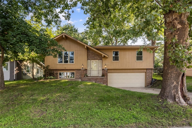 3312 Kinsey Ave, Des Moines, IA 50317 - raised ranch featuring a front yard, brick siding, an attached garage, and concrete driveway