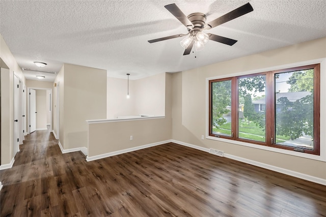 3312 Kinsey Ave, Des Moines, IA 50317 - spare room featuring dark wood-style floors, a textured ceiling, and ceiling fan