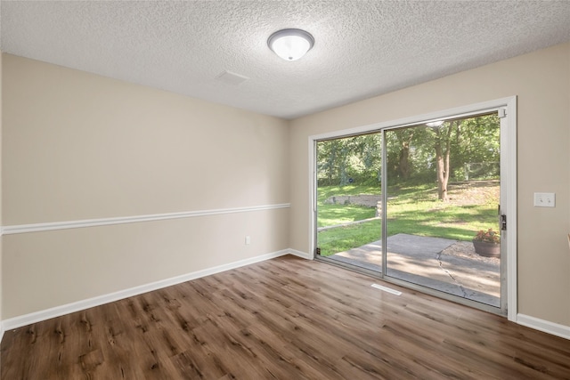 3312 Kinsey Ave, Des Moines, IA 50317 - spare room with wood finished floors and a textured ceiling
