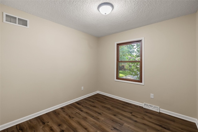 3312 Kinsey Ave, Des Moines, IA 50317 - unfurnished room featuring dark wood-style floors and a textured ceiling