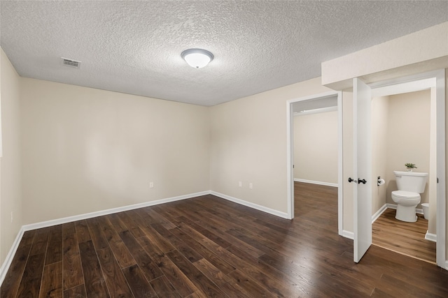 3312 Kinsey Ave, Des Moines, IA 50317 - unfurnished bedroom featuring dark wood finished floors and a textured ceiling