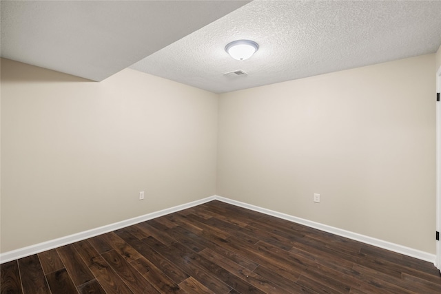 3312 Kinsey Ave, Des Moines, IA 50317 - unfurnished room with dark wood-style flooring and a textured ceiling