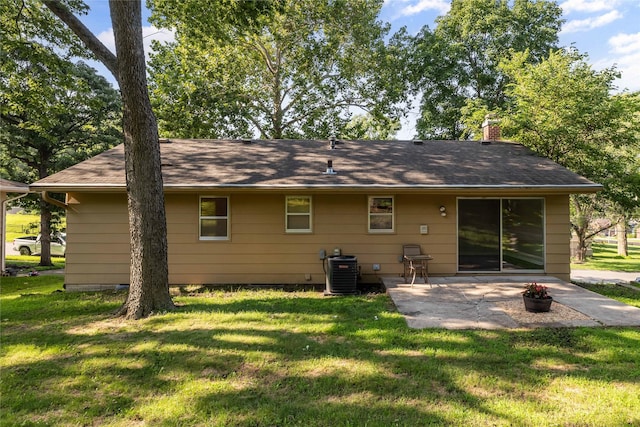 3312 Kinsey Ave, Des Moines, IA 50317 - rear view of house featuring a patio area, a yard, and a chimney