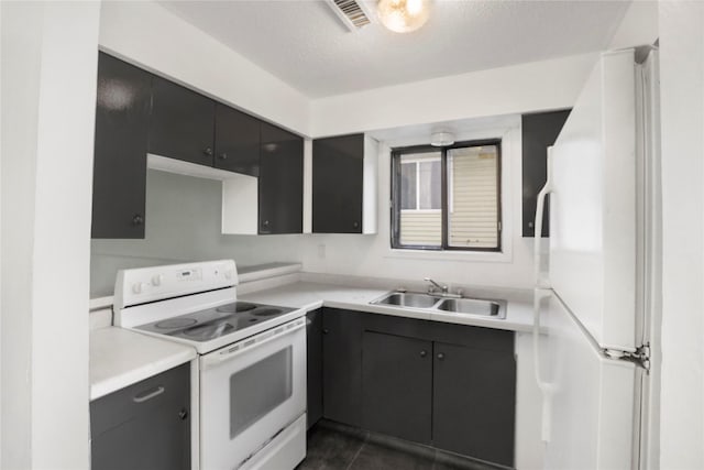 1356 E 17th Ct, Des Moines, IA 50316 - kitchen with white appliances, light countertops, and a textured ceiling