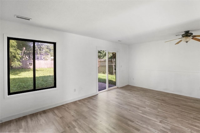 1356 E 17th Ct, Des Moines, IA 50316 - unfurnished room with wood finished floors and ceiling fan