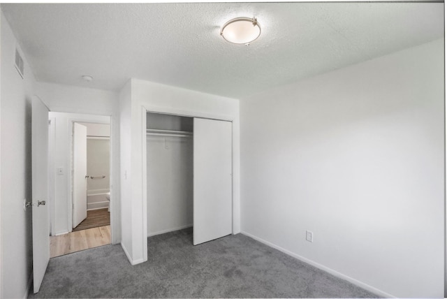 1356 E 17th Ct, Des Moines, IA 50316 - unfurnished bedroom featuring carpet floors, a closet, and a textured ceiling