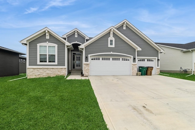 220 11th Ct NW, Bondurant, IA 50035 - craftsman-style home with stone siding, a front lawn, concrete driveway, and a garage