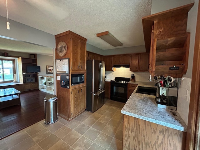 1016 1st St NW, Altoona, IA 50009 - kitchen featuring black appliances, brown cabinets, a textured ceiling, decorative backsplash, and open floor plan