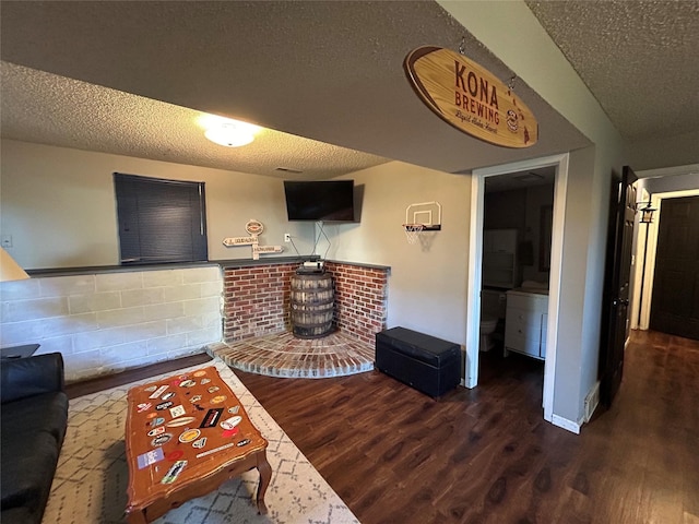 1016 1st St NW, Altoona, IA 50009 - living area featuring a textured ceiling and wood finished floors