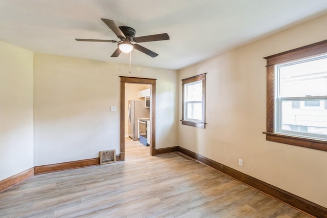 1141 Douglas Ave, Des Moines, IA 50313 - empty room with ceiling fan and light wood-style floors