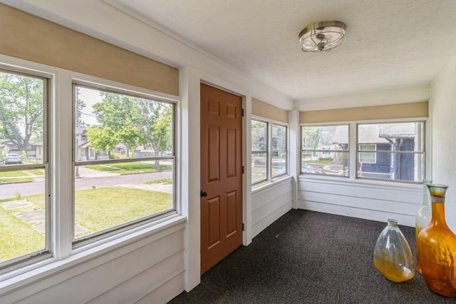 1141 Douglas Ave, Des Moines, IA 50313 - unfurnished sunroom with carpet and plenty of natural light