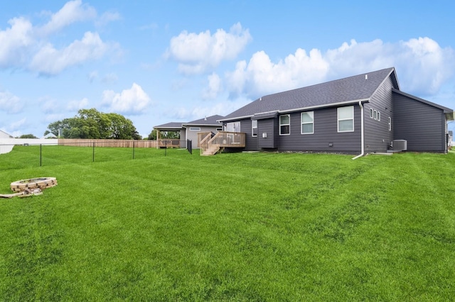 208 11th Ct NW, Bondurant, IA 50035 - rear view of house featuring a fire pit, a deck, and a shingled roof
