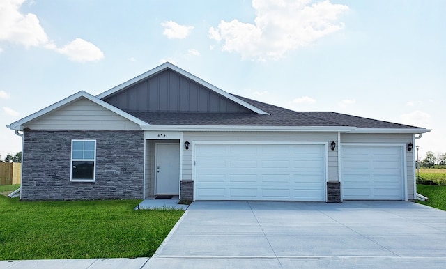 25067 Eagle Vista Dr, Adel, IA 50003 - single story home with board and batten siding, driveway, stone siding, an attached garage, and a front lawn