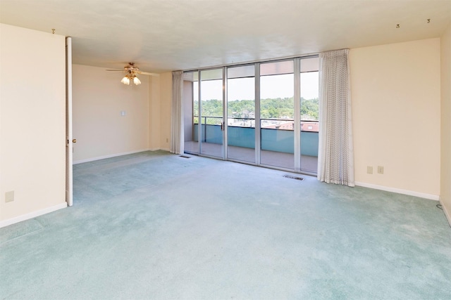 3663 Grand Ave Unit 501, Des Moines, IA 50312 - carpeted empty room with ceiling fan and expansive windows