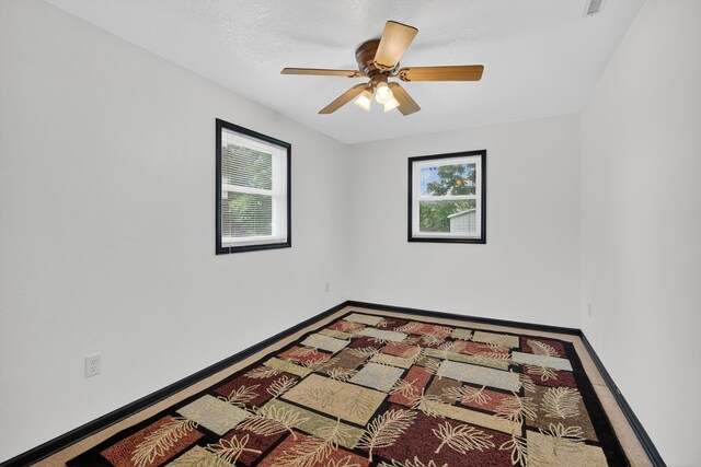 3605 53rd St, Des Moines, IA 50310 - empty room featuring plenty of natural light and a ceiling fan