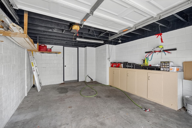 3605 53rd St, Des Moines, IA 50310 - garage featuring concrete block wall and a garage door opener