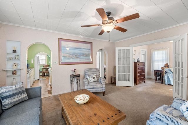4104 1st St, Des Moines, IA 50313 - living area featuring arched walkways, carpet flooring, french doors, crown molding, and a ceiling fan