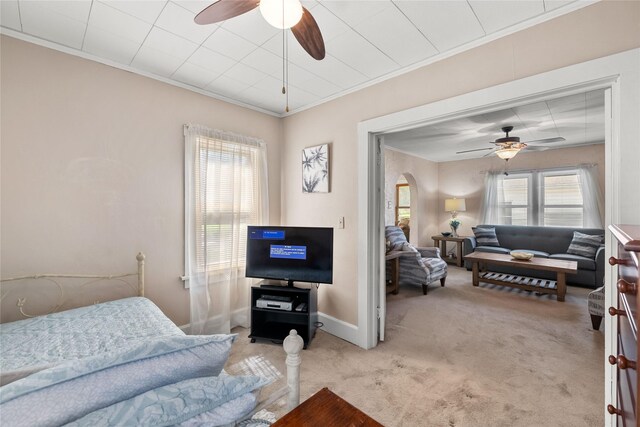 4104 1st St, Des Moines, IA 50313 - bedroom featuring carpet floors, crown molding, arched walkways, and ceiling fan