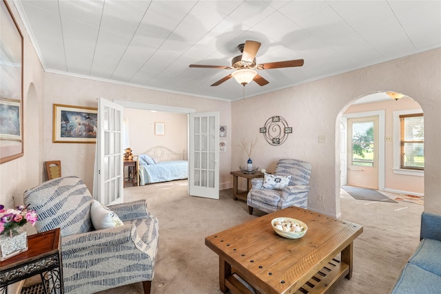 4104 1st St, Des Moines, IA 50313 - carpeted living room with arched walkways, french doors, ceiling fan, and ornamental molding
